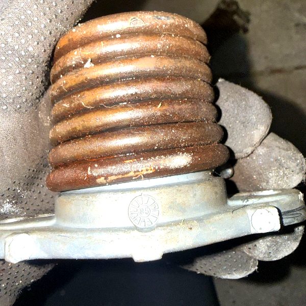 Close-up of damaged garage door hardware, showing the kind of impact damage that affects garage door panels and tracks