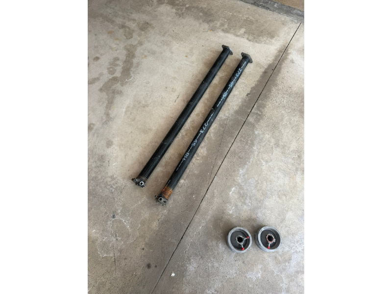 A failed garage door spring, the kind of sudden failure that often follows weeks of warning signs on the cables and drums