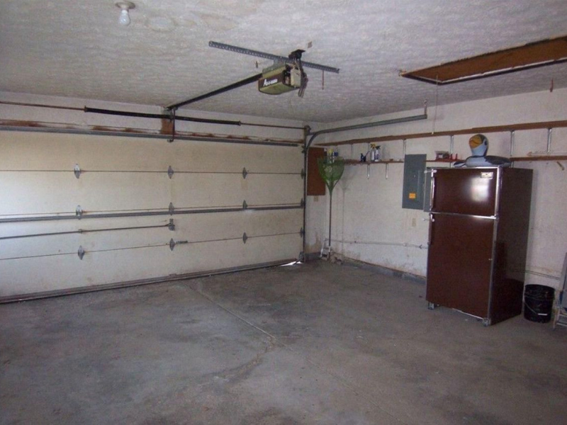 A failed garage door spring on an older door, the kind of repair history that factors into a repair versus replace decision